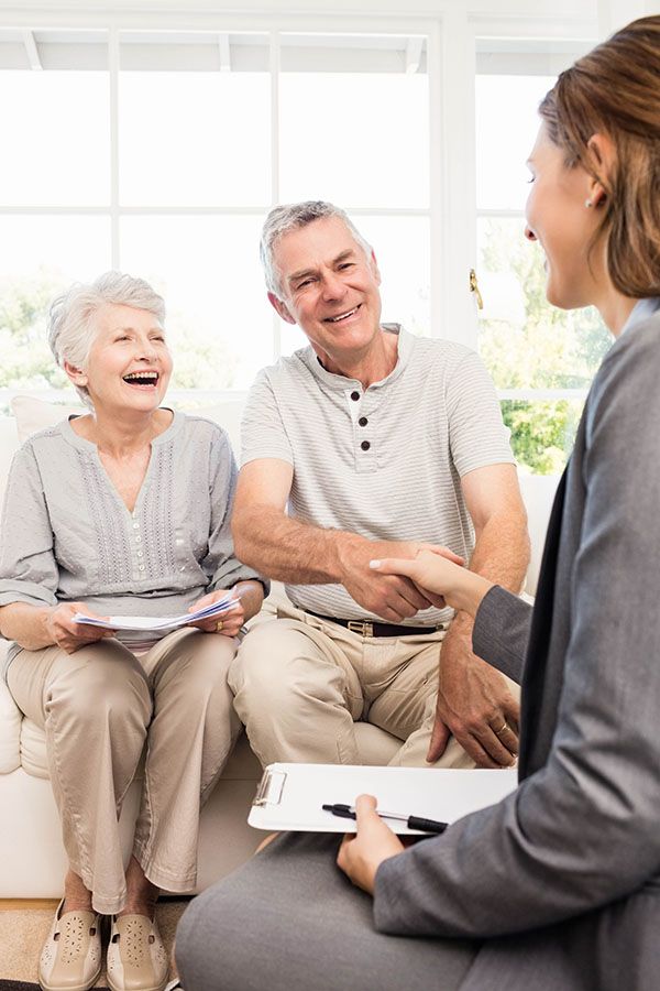 senior husband and wife speaking with a hearing professional
