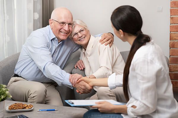 senior couple speaking with a hearing professional